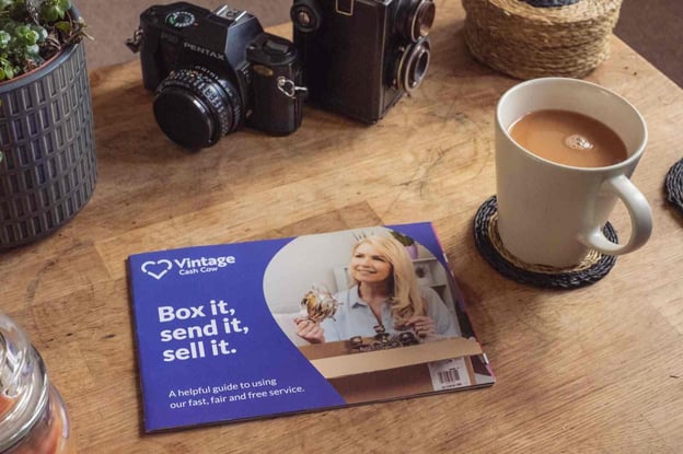coffee table with cup of tea and a vintage cash cow leaflet