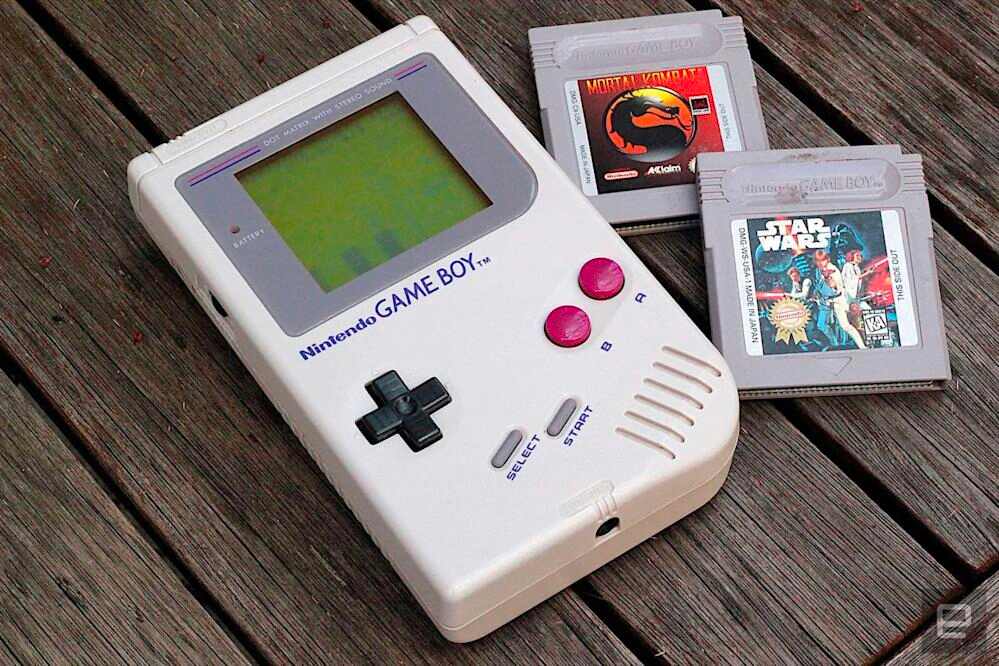 Cream Nintendo Game Boy with a Mortal Kombat and Star Wars game cartridge 