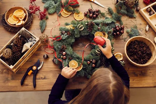 Girl making a sustainable Christmas Wreath 