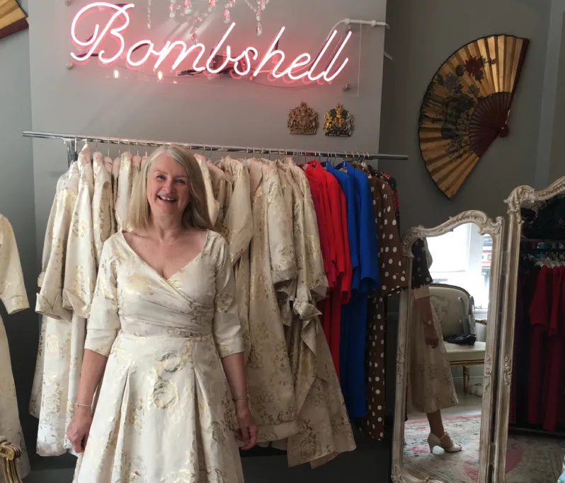 older woman trying on a wedding dress in a shop