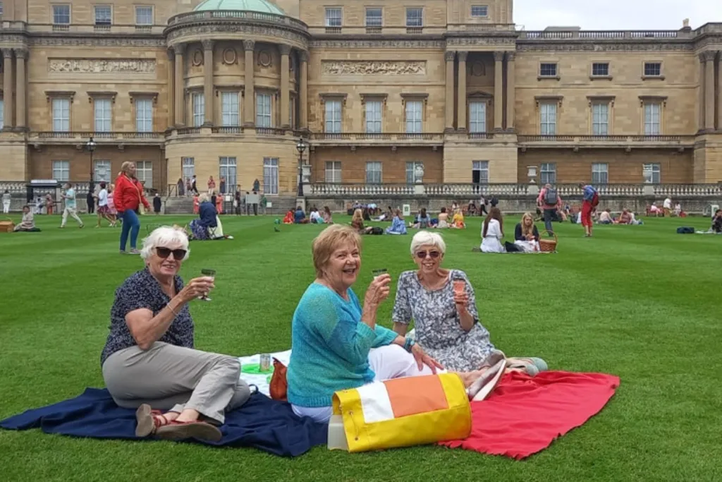 three older ladies drinking champagne on Buckingham Palace lawns