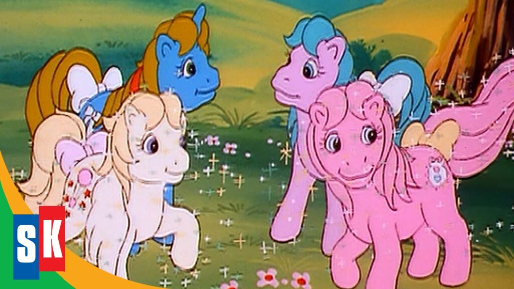 A white, a blue, a lilac and a pink My Little Pony character in a sparkling field