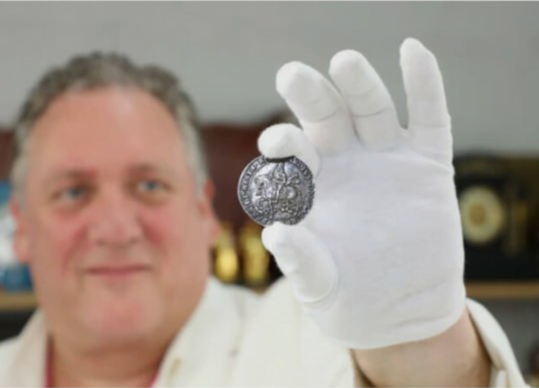 man holding rare coin